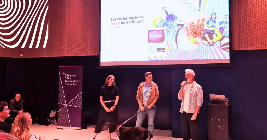 Hilary and Dan stand at the front of the stage.