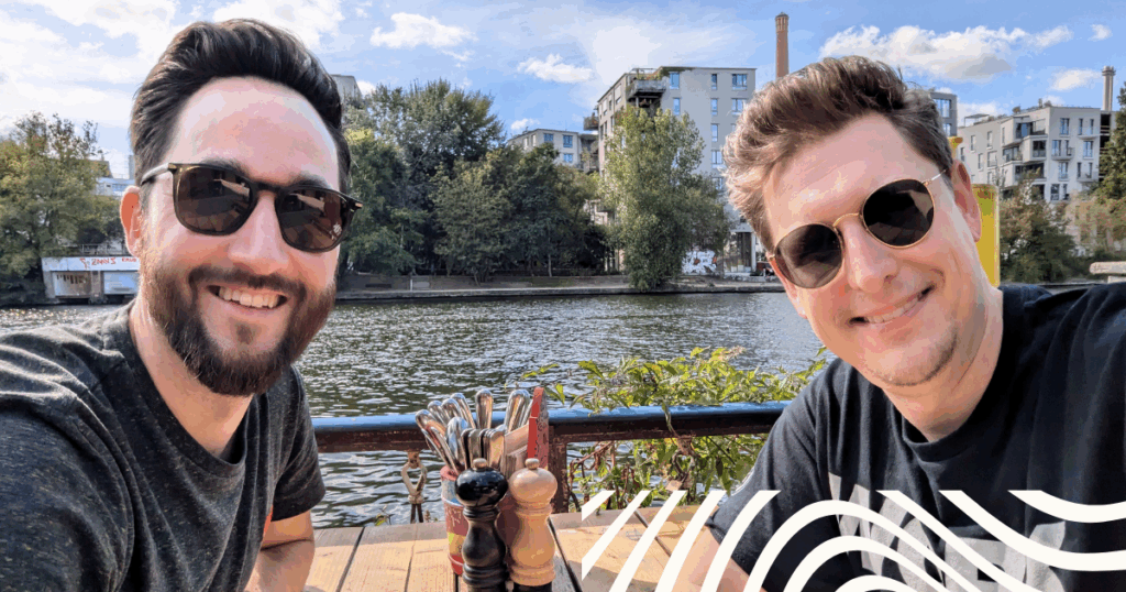 Two men pose for a selfie wearing sunglasses