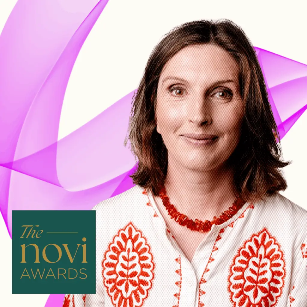 Hilary smiling with Novi Award logo