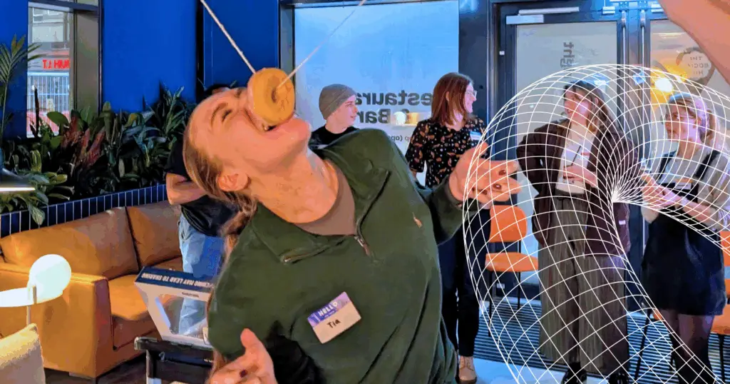 Girl eating a donut from a string.