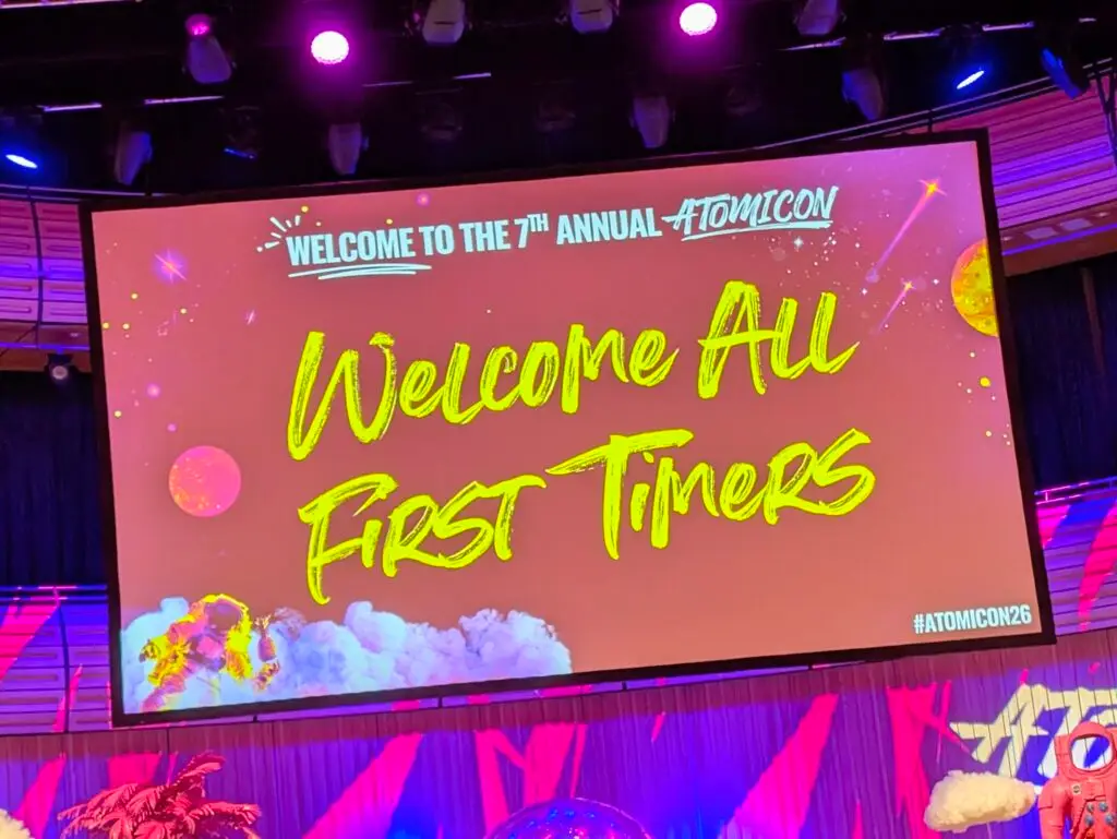 Atomicon brightly coloured screen that says Welcome All First Timers